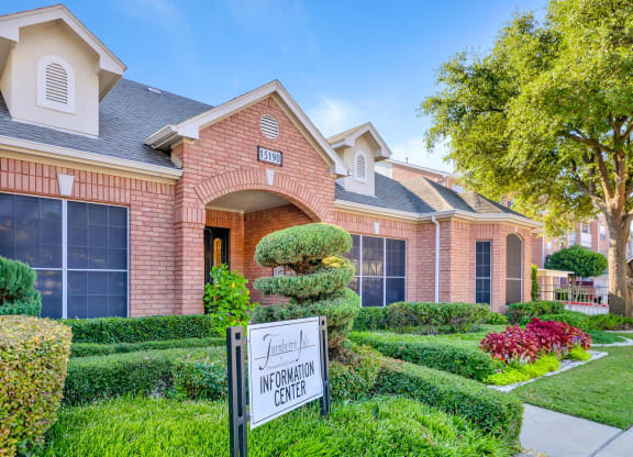 Gorgeous walkup to the leasing office surrounded by trees and flowers at Turnberry Isle Apartments in Dallas, TX offers 1,2 and 3 Bedroom Apartment Homes.