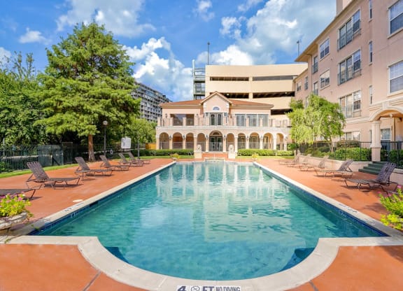 a swimming pool with a building in the background