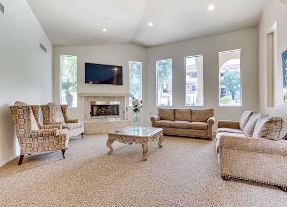 A living room with a fireplace and a television.