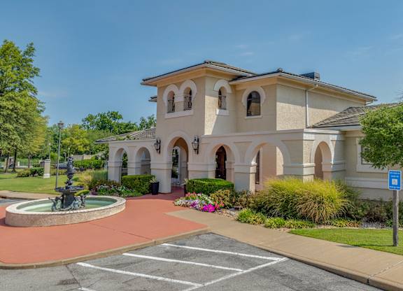 A building with a fountain in front of it.
