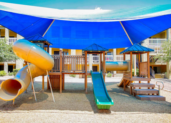 a playground at a resort with a slide