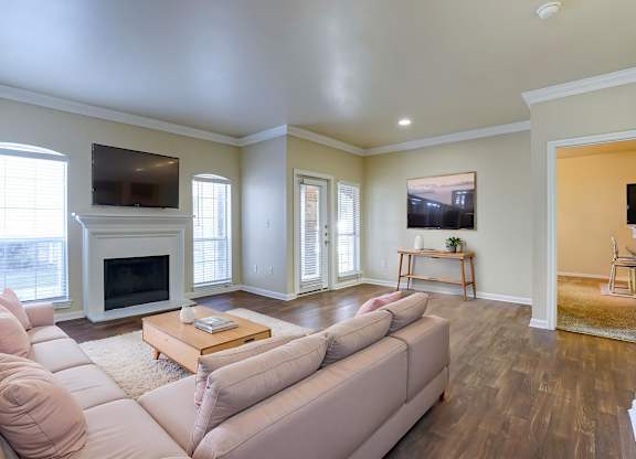A living room with a couch, coffee table, and television.