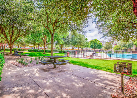Outdoor seating in the courtyard at Tuscany Square Apartments in North Dallas, TX. Now leasing studios, 1 and 2 bedroom apartments.