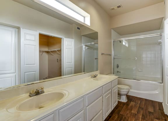 Large bathrooms with ample countertop space and double sinks at Turnberry Isle Apartments in Dallas, TX.