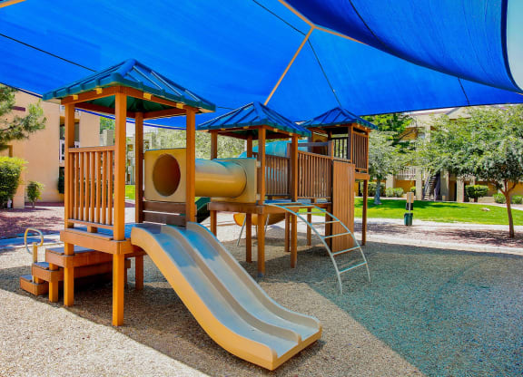 a childrens playground with a slide and playset
