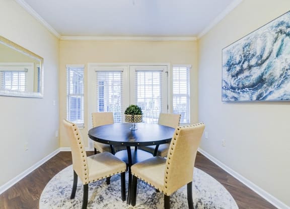 a dining room with a table and chairs