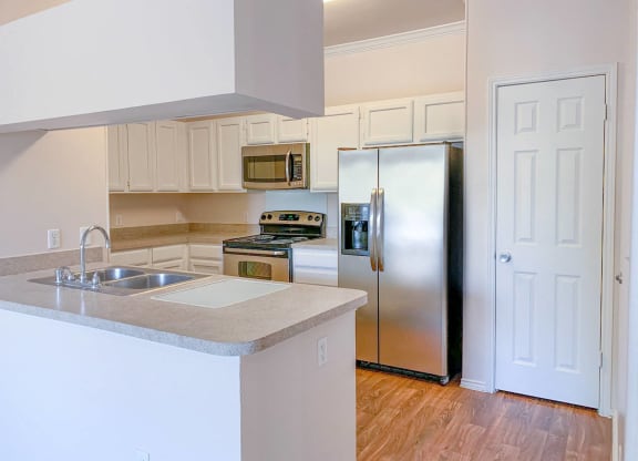Light and bright kitchens and living rooms at Turnberry Isle Apartments in Dallas, TX offers 1,2 and 3 Bedroom Apartment Homes.