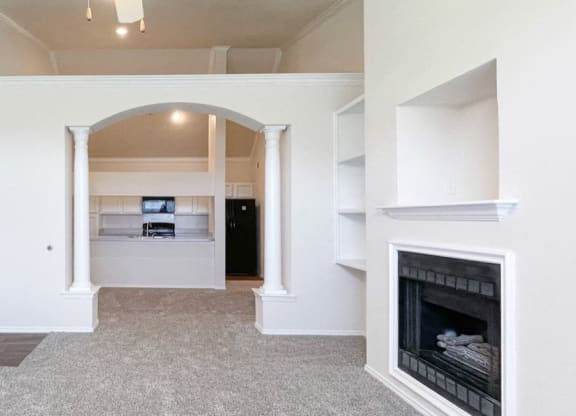 Light and bright living rooms with fireplaces at Turnberry Isle Apartments in Dallas, TX.