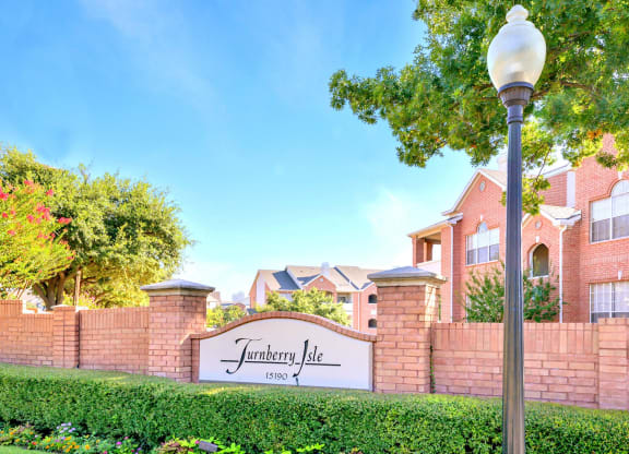 Property monument sign at the property entrance. Turnberry Isle Apartments in Dallas, TX offers 1,2 and 3 Bedroom Apartment Homes.