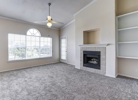 Bright and spacious living rooms with fireplaces at Turnberry Isle Apartments in Dallas, TX.