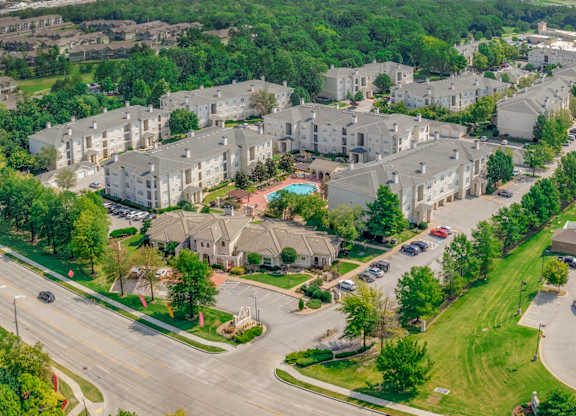 A large apartment complex with a pool in the middle.