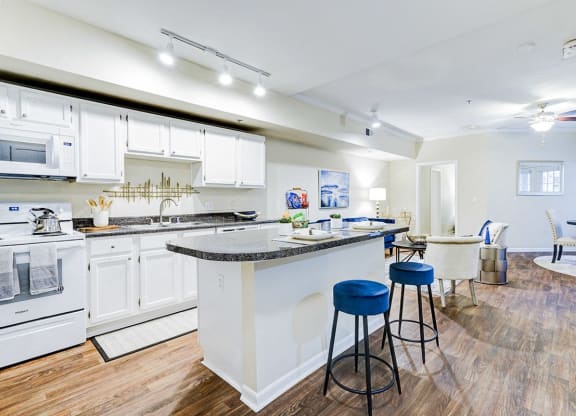 a kitchen with a bar and a living room