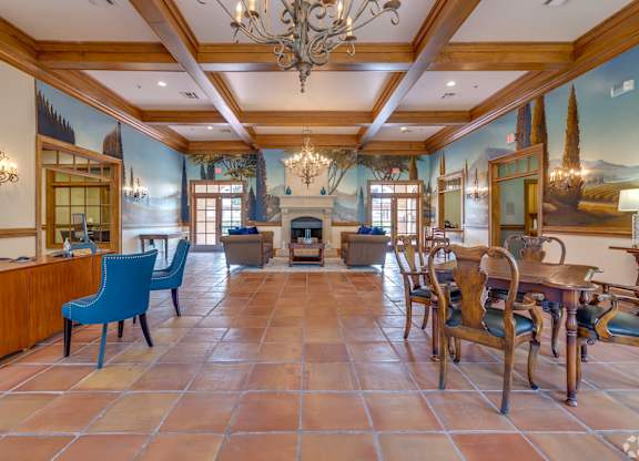 A large room with a fireplace and a chandelier.
