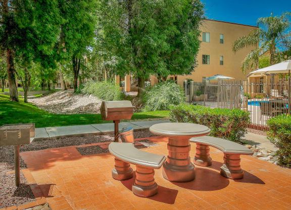 a picnic area with benches and tables in a courtyard