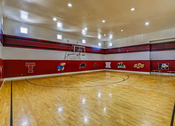 On site basketball gym with red walls  at Cypress Lake at Stonebriar Apartments, Frisco