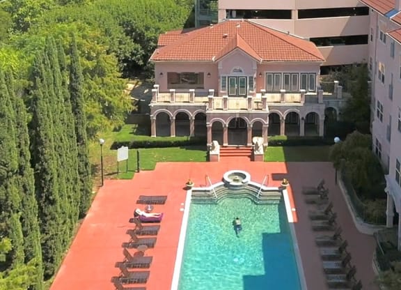 a house with a swimming pool in front of a building