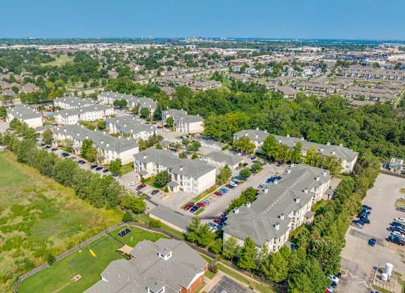 A bird's eye view of a residential area with houses and parked cars.
