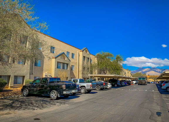 a parking lot with cars parked in front of a building