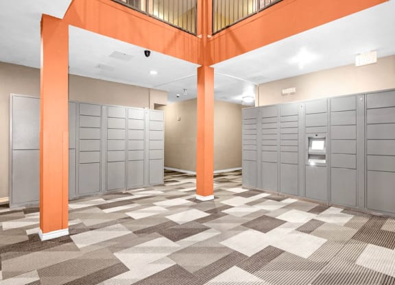 a row of lockers in a room with orange pillars