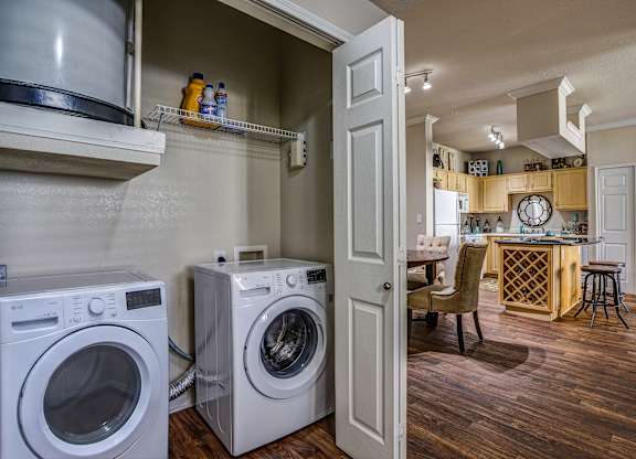 Spacious laundry closet with white doors at Cypress Lake at Stonebriar Apartments, Frisco