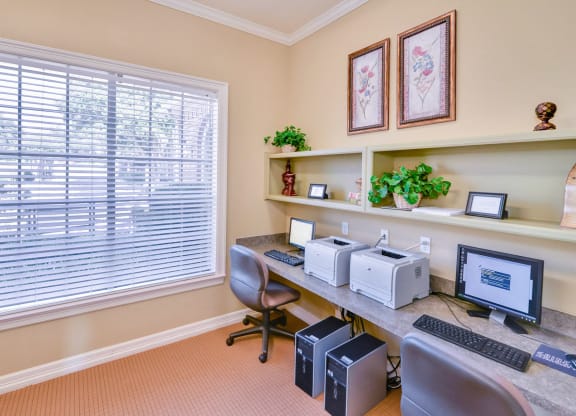 Community business center with computers and chairs.