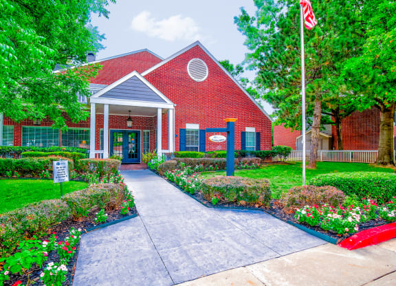 Exterior entrance to red leasing office at Greenbriar Apartments, Oklahoma, 74136