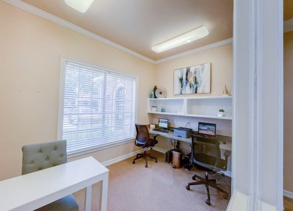 Community business center with computers and chairs.