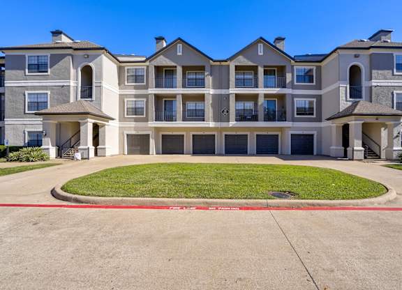 A large apartment complex with a red line painted on the ground.
