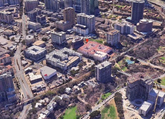 an aerial view of a city with tall buildings