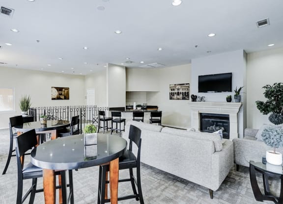 a living room with a fireplace and a table and chairs