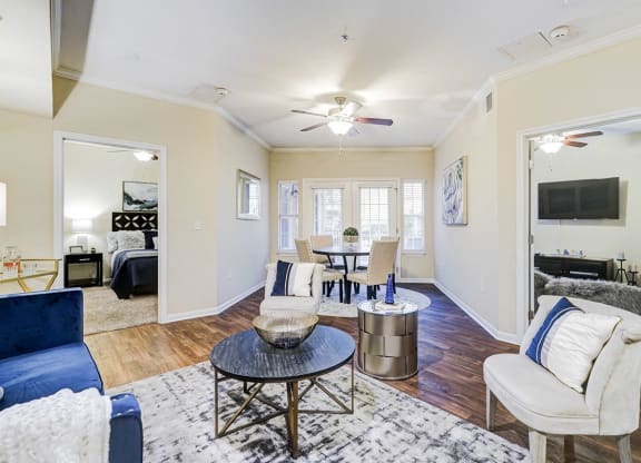 a living room with furniture and a ceiling fan