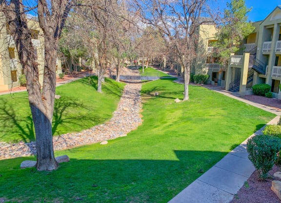 a path through the grass between two apartment buildings