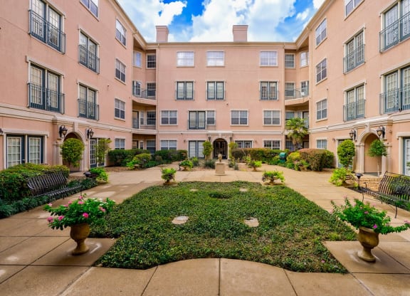 a courtyard with a fountain in the middle of an apartment building