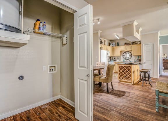 Laundry closets off of the kitchen in apartments at Cypress Lake at Stonebriar in Frisco, TX!
