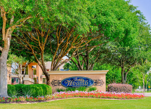 Mature trees at the entrance to The Winsted at Valley Ranch in Irving, TX, For Rent. Now leasing 1 and 2 bedroom apartments.
