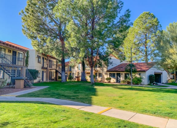 Community  filled with mature trees and lush landscaping at La Hacienda Apartments in Tucson, AZ!