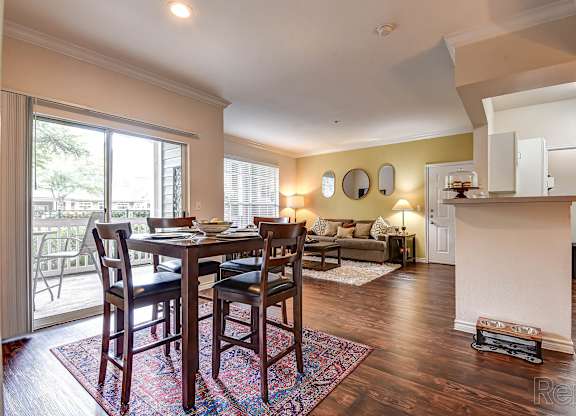 A dining room with a table and chairs.