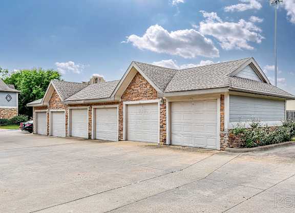A house with a garage and a driveway in front.