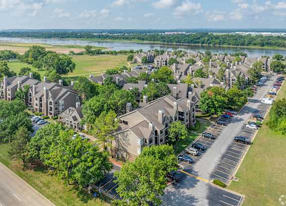 A bird's eye view of a residential area with houses and parked cars.