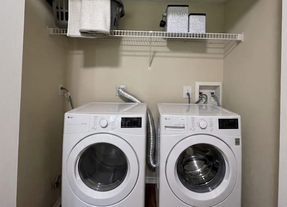A small laundry room with a washer and dryer.