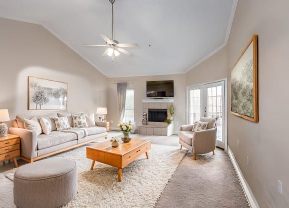 a living room with couches and chairs and a fireplace