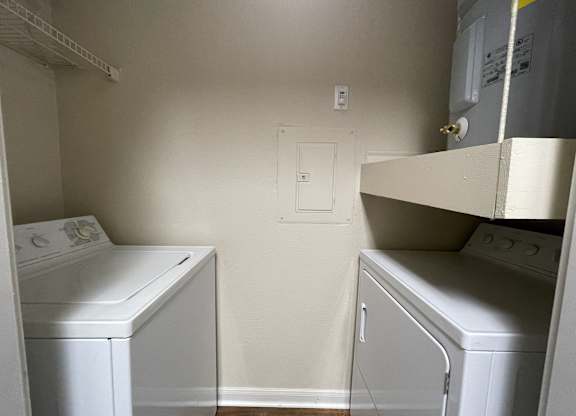 A small laundry room with a washer and dryer.