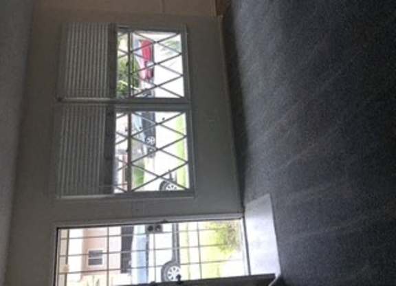 A window with a view of a car and a building.
