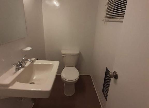 A white sink and toilet in a small bathroom.