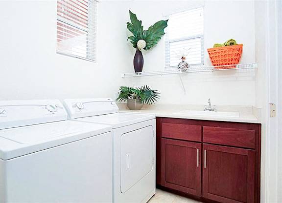 White washing machine and dryer in a laundry room at Croix Townhomes, Henderson, NV