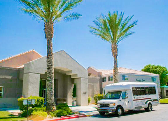 a white van parked in front of a building with palm trees