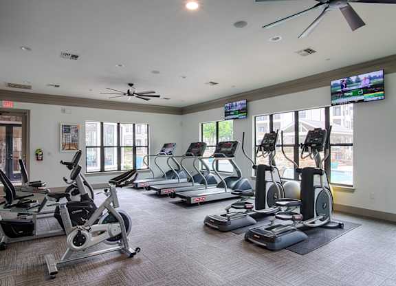 Fitness center with cardio equipment and tvs at Silverado Apartments, Frisco, Texas