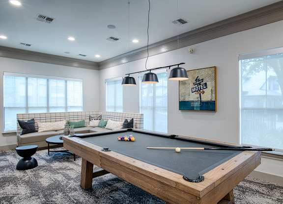 Game room with pool table and lounge seating at Silverado Apartments, Texas
