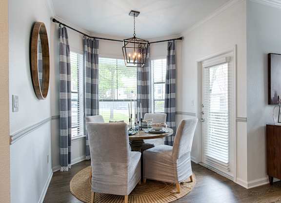 Dining nook with bay windows and chandelier at Silverado Apartments, Frisco, TX 75034