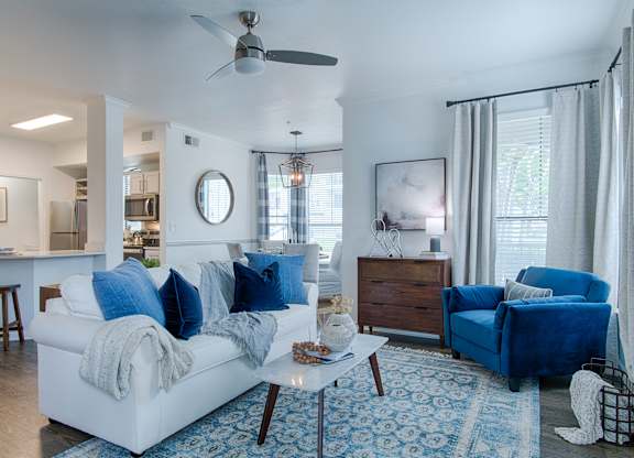 Living room with blue accents and modern furnishings at Silverado Apartments, Frisco, 75034